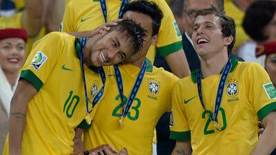 Brazil's forwards Neymar, left, Jadson, centre, and Bernard celebrate after their 3-0 win over Spain. Lluis Gene / AFP