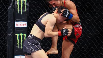 Joanna Jedrzejcyk lands a knee strike on Zhang Weili during their fight at UFC 275. Getty