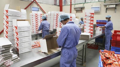 Workers prepare shipments of tomato paste packets at the Chilly Willy manufacturing facility in Dubai, June 3, 2015.