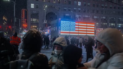People enjoy the snow in Times Square. EPA