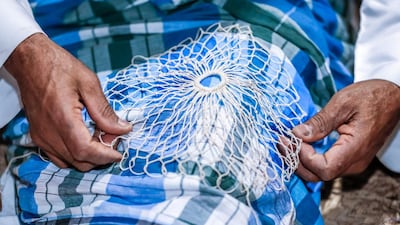 Putting together the net. Victor Besa / The National