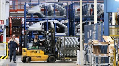 Employees work on the the assembly line of the Maserati brand, at a factory in Grugliasco. MARCO BERTORELLO / AFP
