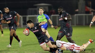 An Abu Dhabi Harlequins player tackles a Dubai Exiles player during the UAE Premiership final.