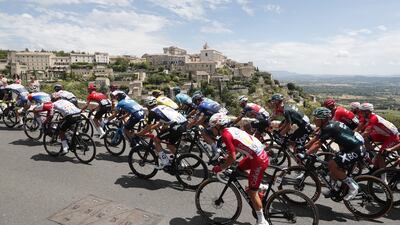 The peloton pass the town of Gordes during Stage 11.