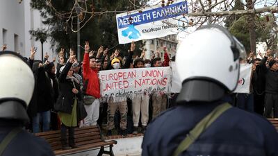 Riot police stand guard as refugees and migrants demonstrate, as tension between the newcomers and island communities in Greece remain high. Reuters