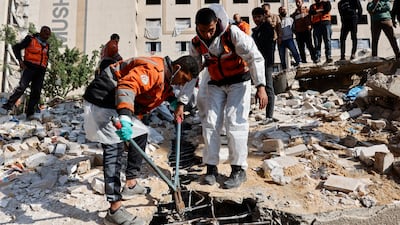 Civil defence workers search for bodies in a destroyed building in the Al Rimal neighbourhood of Gaza city. AFP