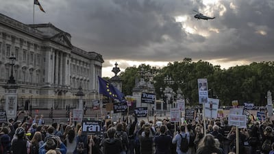 People hold placards in protest over Donald Trump's state visit outside Buckingham Palace. Getty Images