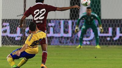 Amer Omar, No 22, of Al Wahda and Youssef Kaddioui of Al Dhafra tussel for the ball during their Arabian Gulf League match on December 4, 2014, at Al Nahyan Stadium in Abu Dhabi. Ravindranath K / The National