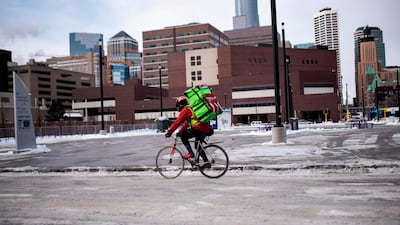 A bicyclist braves the cold while riding through downtown in Minneapolis, Minnesota. AFP