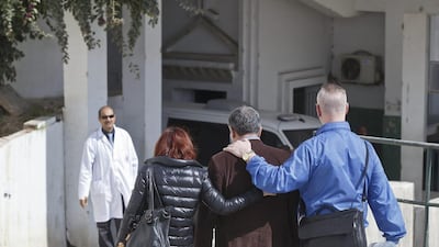 A unidentified relative of a victim of the attack, centre, is escorted by friends at the morgue of the Charles Nicole hospital in Tunis on March 19, 2015. Michel Euler/AP Photo