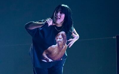 Billie Eilish performs 'Happier Than Ever' with an image of Taylor Hawkins on her T-shirt at the 64th Annual Grammy Awards. AP