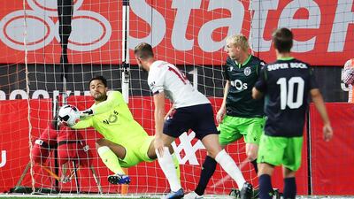 Renan Ribeiro of Sporting makes a save against Jordan Henderson of Liverpool. AFP