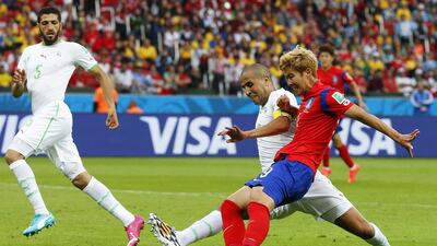 Son Heung-min of South Korea scores his team's first goal to make it 3-1 against Algeria on Sunday at the 2014 World Cup. Armando Babani / EPA