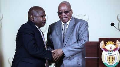 South African president Jacob Zuma, right, shake hands with newly appointed minister of finance David Van Rooyen, left, after a swearing ceremony on December 10, 2015 at the Union Buildings in Pretoria. South Africa’s rand dropped to historic lows on December 10 after president Zuma sacked his respected finance minister in a move that triggered widespread fears about the country’s economic outlook. AFP