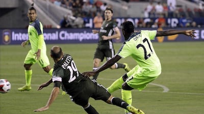 Liverpool’s Divock Origi (27) scores past AC Milan’s Gabriel Paletta (29) during the second half of an International Champions Cup match Saturday, July 30, 2016, in Santa Clara, California. Marcio Jose Sanchez / AP Photo
