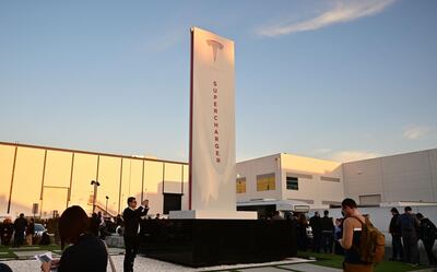 People wait in line for entry to see the unveiling of the new Tesla Model Y beside the Supercharger at the Tesla Design Centre in California. AFP