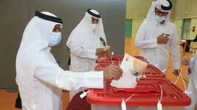Men vote in legislative elections in Qatar. AP Photo