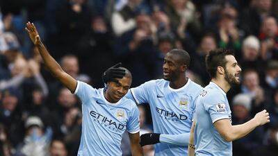 Manchester City's Fernandinho, left, celebrates with teammates after scoring a goal against Arsenal at Etihad Stadium on Saturday. Darren Staples / Reuters