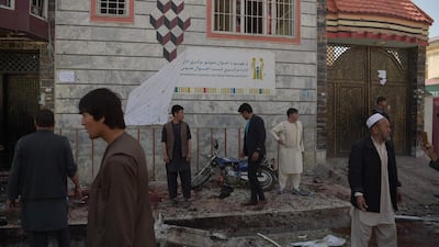 Afghan residents inspect the site of a suicide bombing outside a voter registration centre in Kabul on April 22, 2018. Shah Marai / AFP