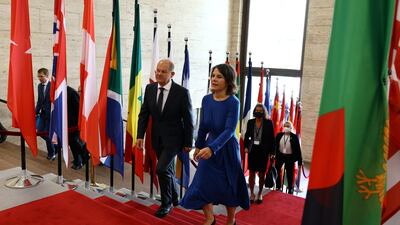 German Chancellor Olaf Scholz and German Foreign Minister Annalena Baerbock arrive at the two-day Petersberg Climate Dialogue in Berlin, Germany. Reuters