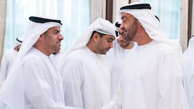 Sheikh Mohamed bin Zayed (right), greets a member of the Ministry of Presidential Affairs, during an iftar reception, at Abu Dhabi's Al Bateen Palace.