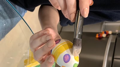 Make sure to brush the cut-outs on the egg's surface gently, lest you tear the napkin