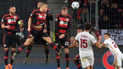 Miralem Pjanic of AS Roma scores from the free-kick to make it 3-2 during the Champions League match against Bayer Leverkusen on Tuesday. Federico Gambarini / EPA