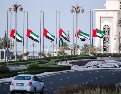 UAE flags at Qasr Al Watan at half-mast on Thursday morning to mark the death of Sheikh Saeed bin Zayed. Victor Besa / The National