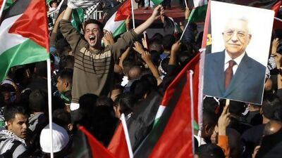 Palestinians in Ramallah cheer near a placard depicting Palestinian Authority president Mahmoud Abbas after the UN General Assembly upgraded their status from ‘observer entity’ to ‘non-member state’.