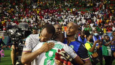 Comoros midfielder Fouad Bachirou is consoled by teammates after defeat to Cameroon. AFP