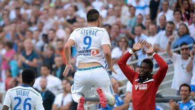 Marseille's Andre-Pierre Gignac, centre, jumps as he celebrates one of his two goals against Rennes on Saturday in a Ligue 1 victory. Boris Horvat / AFP / September 20, 2014