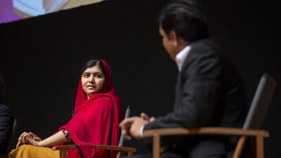Malala Yousafzai listens as her father Ziauddin speaks at the Emirates Palace hotel on Wednesday night. Reem Mohammed / The National
