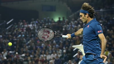 Federer unleashes a shot from the back of the court. EPA