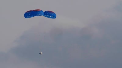 Blue Origin's New Shepard capsule parachutes safely down to the launch area with passengers Jeff Bezos, founder of Amazon and space tourism company Blue Origin, his brother Mark Bezos, Oliver Daemen, and Wally Funk, near Van Horn, Texas, Tuesday. AP Photo
