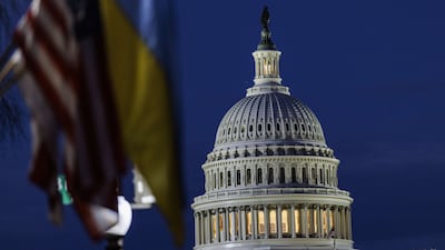 The US Capitol building can be seen past American and Ukrainian flags that were hung on the light posts lining Pennsylvania Avenue on Tuesday night. AFP