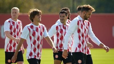 Girona's Spanish coach Michel, centre, leads a training session on the eve of the Uefa Champions League meeting with Paris Saint-Germain. EPA