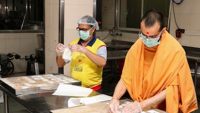 Food is packed by volunteers and priests from the Baps Swaminarayan Sanstha in Delhi for Covid-19 patients.