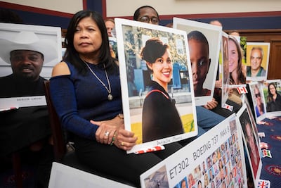 People hold pictures of the victims of Boeing 737 Max accidents on Capitol Hill, in Washington, in December 2019. Lawyers for families of crash victims have in recent months hailed the US Justice Department’s findings. AFP