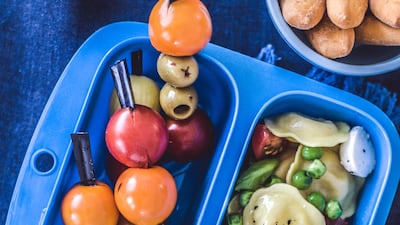 Leftovers lunch box pasta, pesto, mini mozarella balls close up