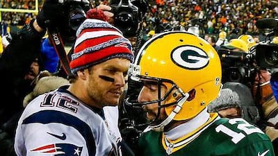New England Patriots quarterback Tom Brady, left, and Green Bay Packers quarterback Aaron Rodgers come together after the final play in the second half of their American Football game at Lambeau Field in Green Bay, Wisconsin, USA, 30 November 2014. The Packers defeated the Patriots. EPA/TANNEN MAURY