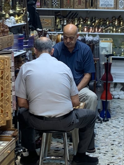 Storekeepers in Jerusalem’s Old City playing a game of backgammon. Hamza Hendawi / The National