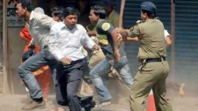 A policeman wielding a baton charges hardline Maharashtra Reconstruction Party supporters in Mumbai last month.