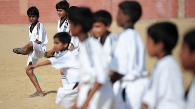 Youth in Karachi, Pakistan train at a local pitch as part of an academy funded by the Real Madrid Foundation. Asif Hassan / AFP