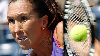 Jelena Jankovic makes a return during her match with Simona Halep, of Romania, during their first round match at Flushing Meadows last night, which the Serbian No 4 seed won.