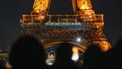 The Eiffel Tower lits the night with the a slogans "Stop Executions in Iran" and "Woman, Life, Freedom" in support for the protests across Iran in Paris, Monday, January 16, 2023. AP