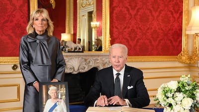 US President Joe Biden, accompanied by first lady Jill Biden, signs a book of condolence at Lancaster House in London following the death of Queen Elizabeth II. AFP