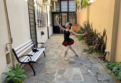 Paz Schattenhofer, 11, poses for a photograph in Buenos Aires, Argentina. Schattenhofer is participating in an international dance competition that encourages people to dance from home, as most theatres are closed due to the coronavirus outbreak. Reuters
