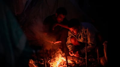 People light a bonfire to cook dinner at the Trampolin beach settlement following the mass crossing of migrants from Morocco, in Ceuta. Reuters