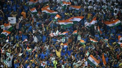 Supporters cheer for India’s Virat Kohli after he hit a six in the World T20 cricket tournament match between India and Australia at The Punjab Cricket Stadium Association Stadium in Mohali on March 27, 2016. AFP / MONEY SHARMA