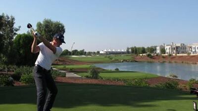 Robert Karlsson hits his tee shot on the 18th hole during his impressive first round at the Earth Course in Dubai yesterday.